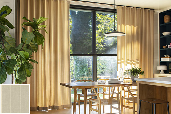 Colorful curtains made of Dashing Stripe in Palomino add a bright gold color to a kitchen and dining room area