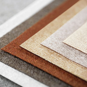 Product shot of Holland & Sherry wool flannel in various colors stacked one on top of another on a right angle