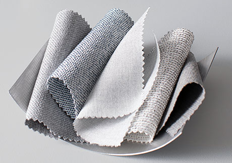 Swatches of Sunbrella material are piled decoratively ina bowl, showing their neutral colors and crisp look and feel