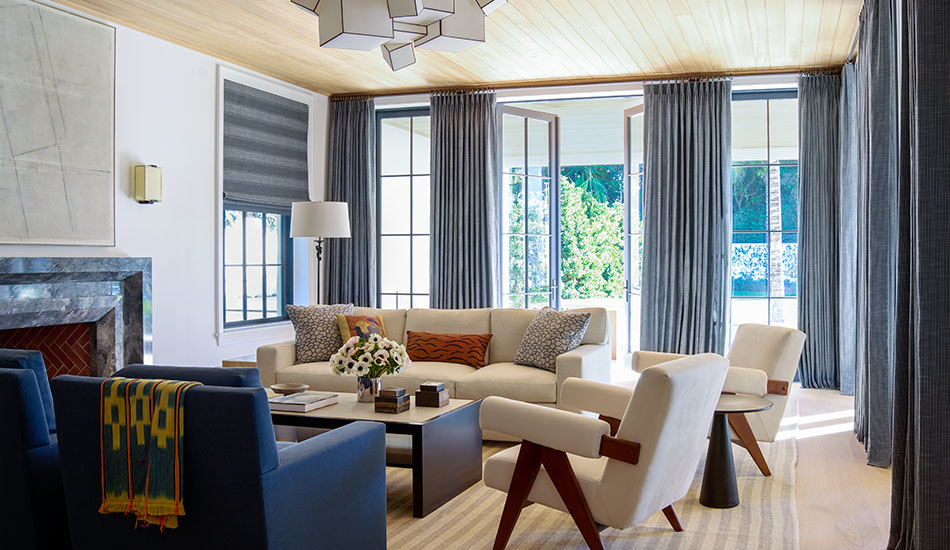 Tall dramatic drapery of Jasmine fabric in bold Midnight show the difference in aesthetic effect between blinds vs curtains