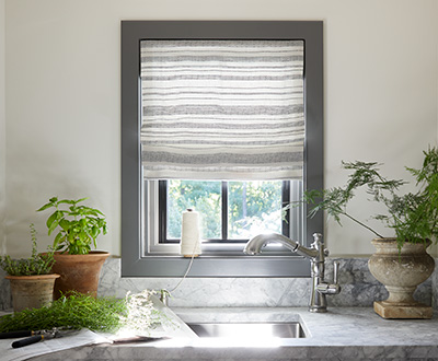 Roman shades for windows include a Flat Roman Shade made of Tidal Line in Slate with privacy lining for some light filtration