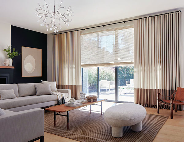 Neutral curtains made of Andes in Castle Wall and a bottom border of Andes in Rye add dimension to a contemporary living room