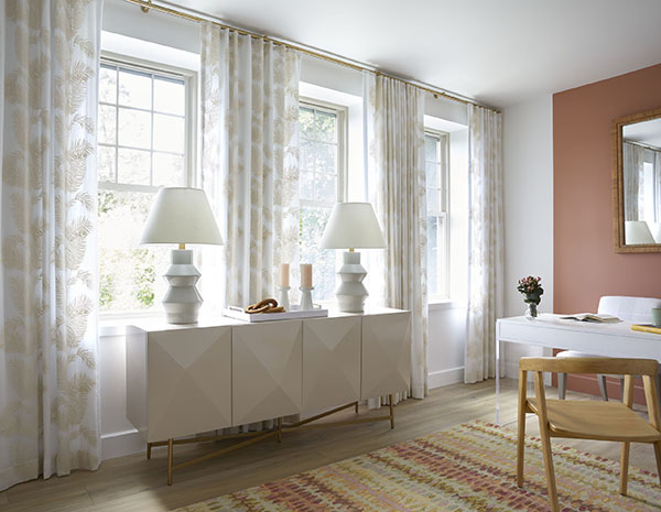 Ripple Fold Drapery made of Palmier in Sand adds a charming botanical element to a boho home office with light wood tones