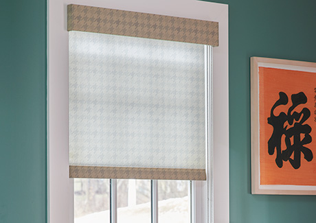 Light filtering Roller Shade made of Houndstooth in Cargo allows soft light to filter into a bright turquoise room