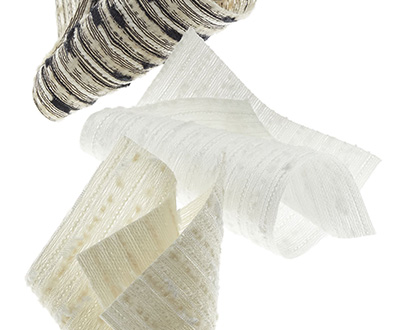 Swatches made of Savoir for Roller Shades for Windows hang suspended in the air with a white background
