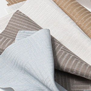 Swatches of Sheila Bridges' Aerial in multiple colors are folded together and showcase the subtle linear design