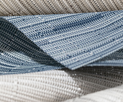 Swatches made of Chilewich Bamboo for Solar Roller Shades for Windows are folded closely together and feature an open weave