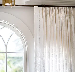 Tailored Pleat Drapery of Feather Palm Embroidery in Vintage Lace is unlined to filter and soften light for a delicate look