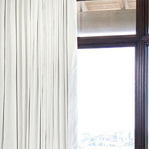 Tailored Pleat Drapery made of Linen in Ivory features blackout lining for a room darkening effect ideal for sleep