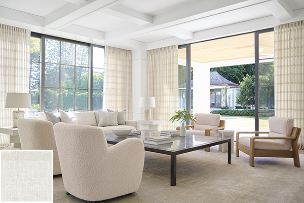 Colorful curtains made of Lily in Buff feature east-west stripes that add subtle visual interest to a warm-toned living room