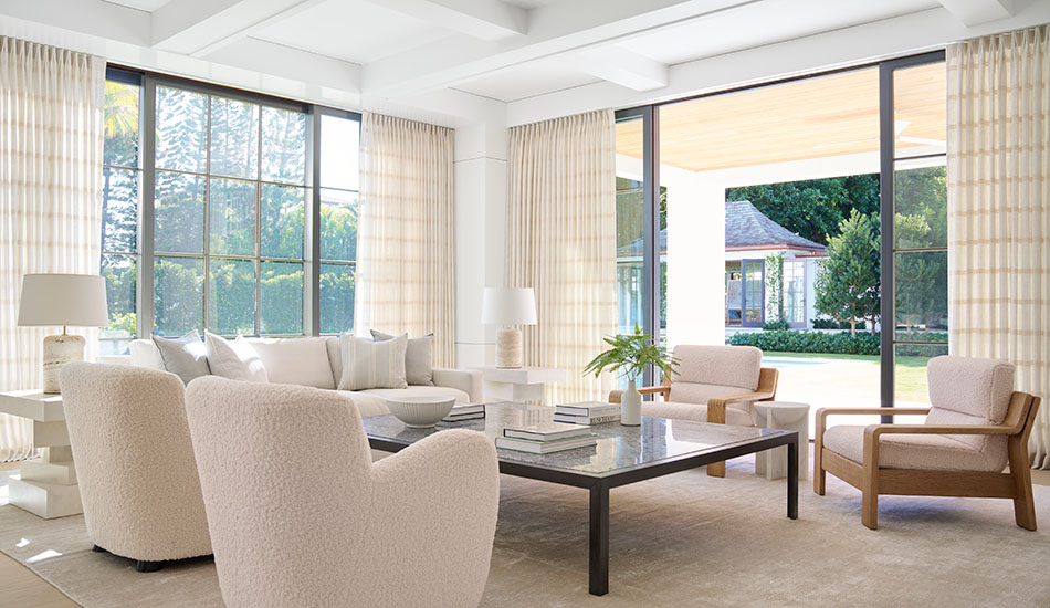 Tailored Pleat neutral curtains made of Victoria Hagan Lily in Buff are warm and inviting in a bright living room